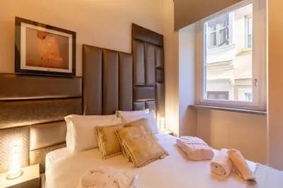 a bedroom with a bed with towels on it at Fontana di Trevi Roma Luxury in Rome