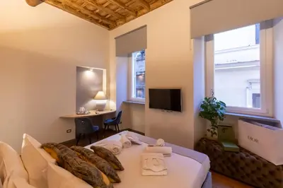 a living room with a couch and a tv at Fontana di Trevi Roma Luxury in Rome