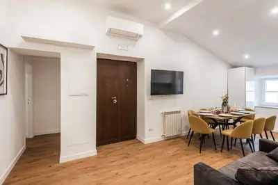 a living room with a table and chairs and a television at The Best Rent - Refined multi-room apartment in Termini area in Rome