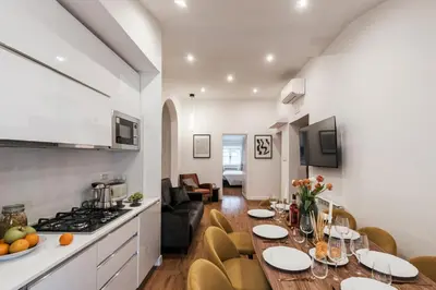 a kitchen and dining room with a table and chairs at The Best Rent - Refined multi-room apartment in Termini area in Rome