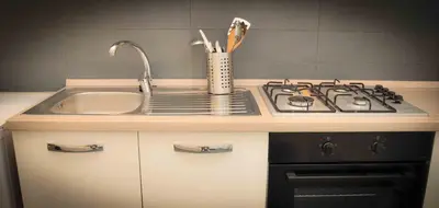a kitchen counter with a sink and a stove at Rome Together Guest House in Rome