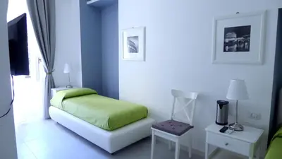 a bedroom with a bed with a green blanket at Rome Together Guest House in Rome