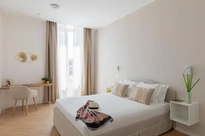 a white bedroom with a bed and a desk at iFlat La Dolce Vita - Contemporary Luxury in Rome in Rome