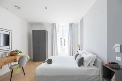 a white bedroom with a bed and a desk at iFlat La Dolce Vita - Contemporary Luxury in Rome in Rome
