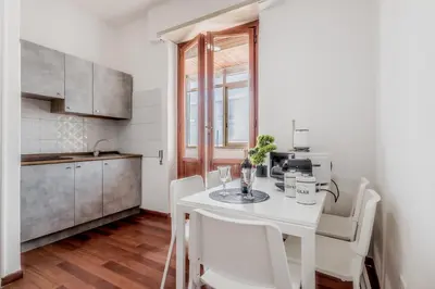 a kitchen with a white table and white chairs at NEW OPENING Free Netflix BIG APT Pamphili House in Rome