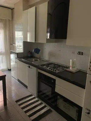 a kitchen with white cabinets and a stove top oven at St Peter view House Vatican in Rome