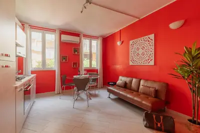 a red living room with a couch and a table at Urban Loft Piramide in Rome