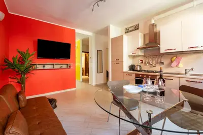 a kitchen with a glass table and a red wall at Urban Loft Piramide in Rome