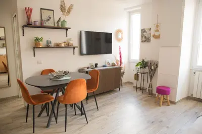 a dining room with a table and chairs and a tv at Via Rocca House in Rome