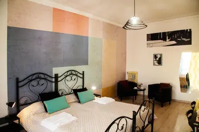 a bedroom with a bed with green pillows on it at City Lights Rome in Rome