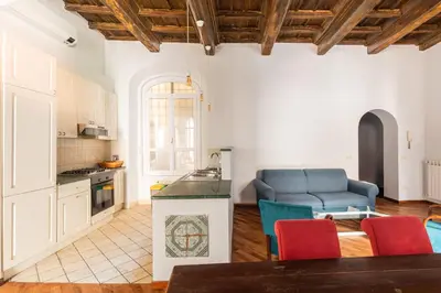 a kitchen and living room with a blue couch at Trastevere Charming Apartment by RomeLoft in Rome