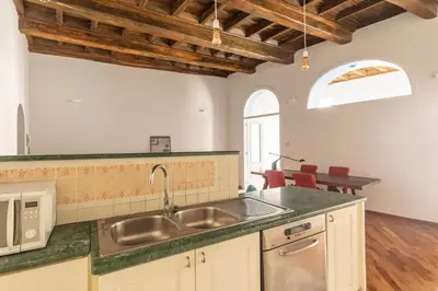 a kitchen with a sink and a counter top at Trastevere Charming Apartment by RomeLoft in Rome