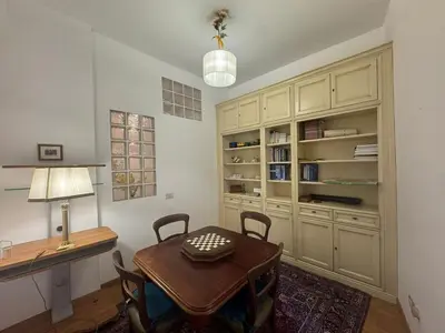 a dining room with a table and a desk at Spacious Getaway with Roman Charm in Rome