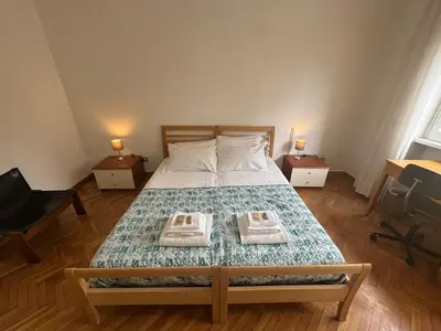 a bedroom with a bed with two towels on it at Spacious Getaway with Roman Charm in Rome
