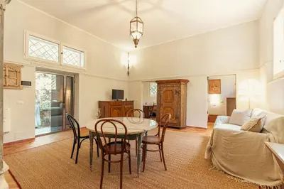 a living room with a table and chairs and a couch at Casa di NOAH in Rome