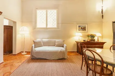 a living room with a table and a chair at Casa di NOAH in Rome