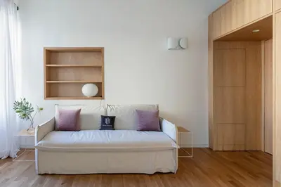 a living room with a white couch with purple pillows at Design Suite apartment Piazza di Spagna in Rome