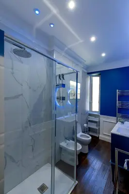 a bathroom with a glass shower and a toilet at PapaRoma Suite in Rome