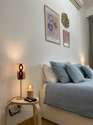 a bedroom with a bed and a table with a lamp at MarVal Vatican House in Rome