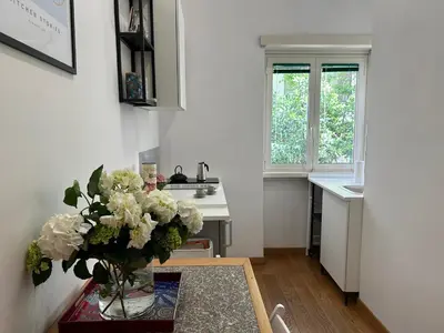 a kitchen with a vase of flowers on a table at MarVal Vatican House in Rome