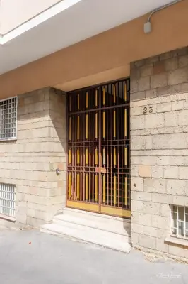 a building with a barred window on the side of it at Magikrooms Luxury in Rome