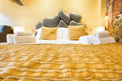 a bedroom with a large bed with white pillows at Magikrooms Luxury in Rome
