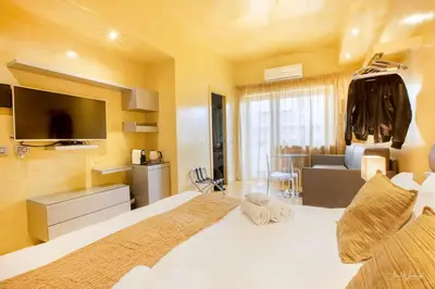 a bedroom with a bed with a television and a couch at Magikrooms Luxury in Rome