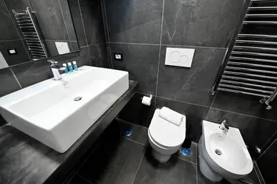 a bathroom with a white sink and a toilet at Why Not Apartment in Rome