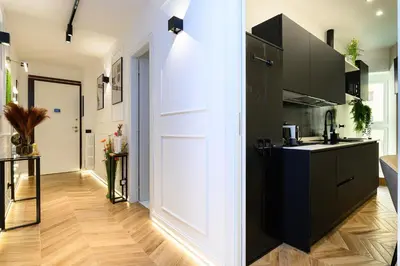 a kitchen with black cabinets and a white door at Rome Elegant Suite in Rome