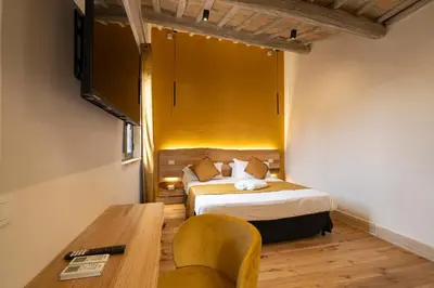 a hotel room with a bed and a desk and a table at Terrace 34 in Rome