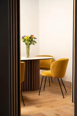 a table and two chairs with a vase of flowers at Terrace 34 in Rome
