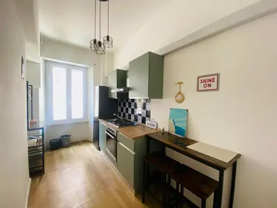 a kitchen with green cabinets and a counter top at Domus 14 in Rome
