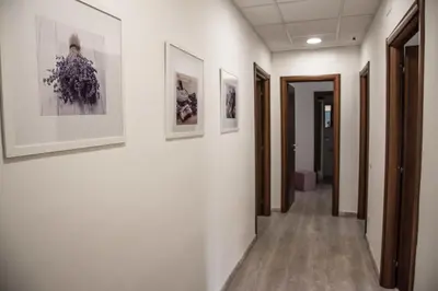 a hallway in a hospital with paintings on the walls at Grandis Rooms in Rome