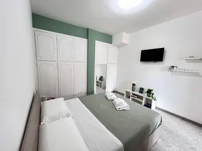 a bedroom with a large bed with two towels on it at Nala's Vatican House in Rome