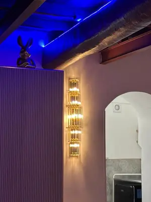 a room with a wall with lights on it at Suite at the Coliseum in Rome