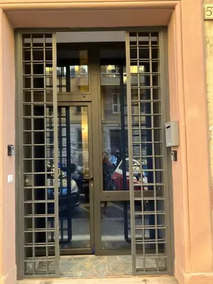 a glass revolving door in a building with a person in it at Principe Umberto piano terra in Rome