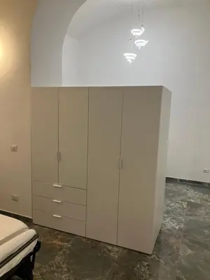 a bedroom with a bed and a white cabinet at Principe Umberto piano terra in Rome