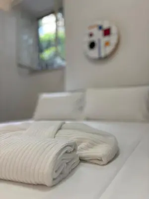 a stack of white towels sitting on top of a counter at Aventino Urban Place by One Up Hospitality in Rome