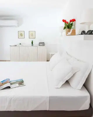 a bedroom with a white bed with a book on it at Mini apartment Cairoli 1 - Zeno 42 in Rome