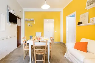 a living room with a table and a couch at Suite Laterani 3 bedrooms with parking in Rome