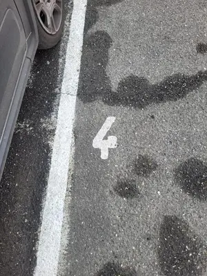 a handicapped symbol on a street next to a car at Suite Laterani 3 bedrooms with parking in Rome
