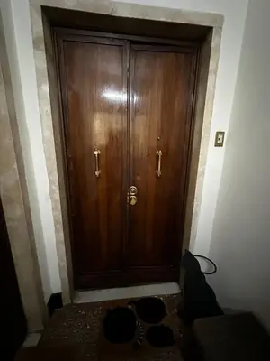 a large wooden door in a room with shoes at Casa Letizia - Rome Prati Vatican - Intero appartamento in Rome