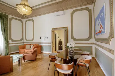 a living room with a table and chairs at Domus Regia - Luxury Experience in Rome