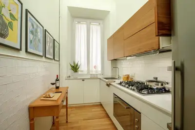 a kitchen with a stove and a counter top at Domus Regia - Luxury Experience in Rome