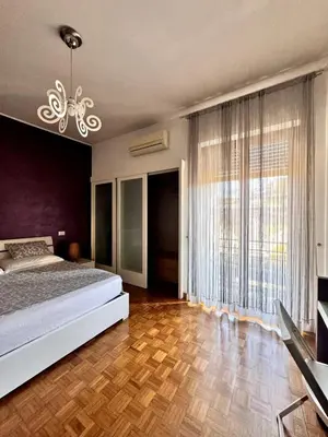 a bedroom with a bed and a large window at Raffaella Vatican House in Rome