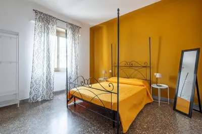 a bedroom with a bed and a yellow wall at Three large bedrooms for six people Rome downtown apartment in Rome