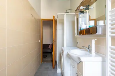 a bathroom with a sink and a mirror at Three large bedrooms for six people Rome downtown apartment in Rome