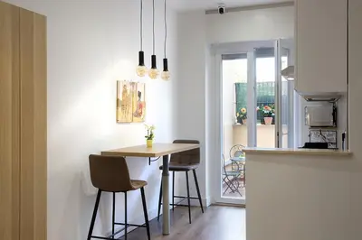 a kitchen with a table and chairs in a room at Charme Holidays Puccini in Rome