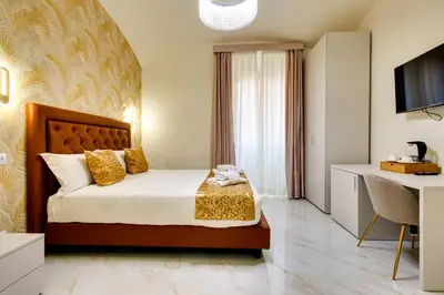 a hotel room with a bed and a desk at Dimora Merulana 183 in Rome