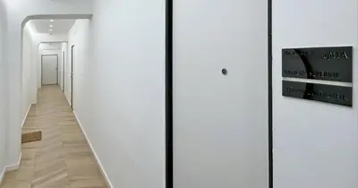 a hallway with white walls and a hallway with white doors at YCH-Vatican Superior Suite in Rome